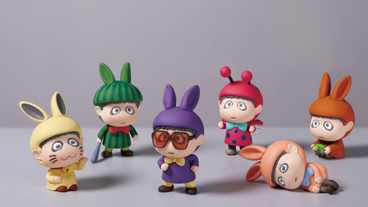 Set of colorful cartoon character figurines on a gray background